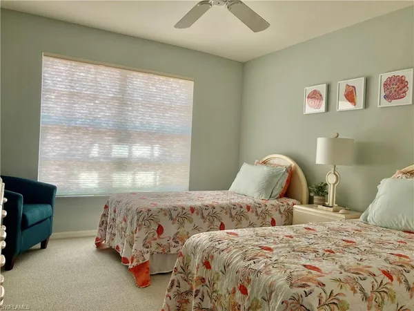 a bedroom with a bed and glass window