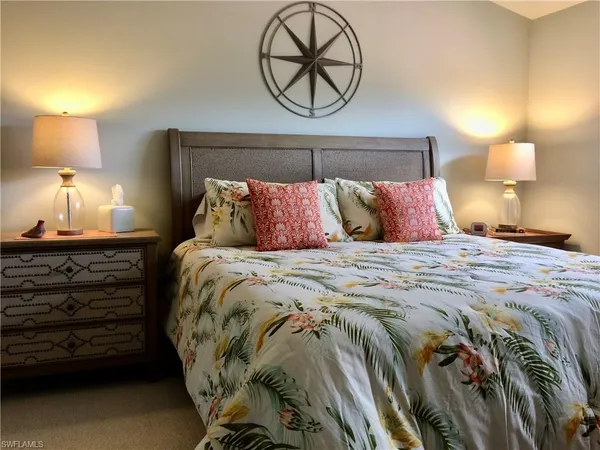 a bedroom with a bed and a lamp