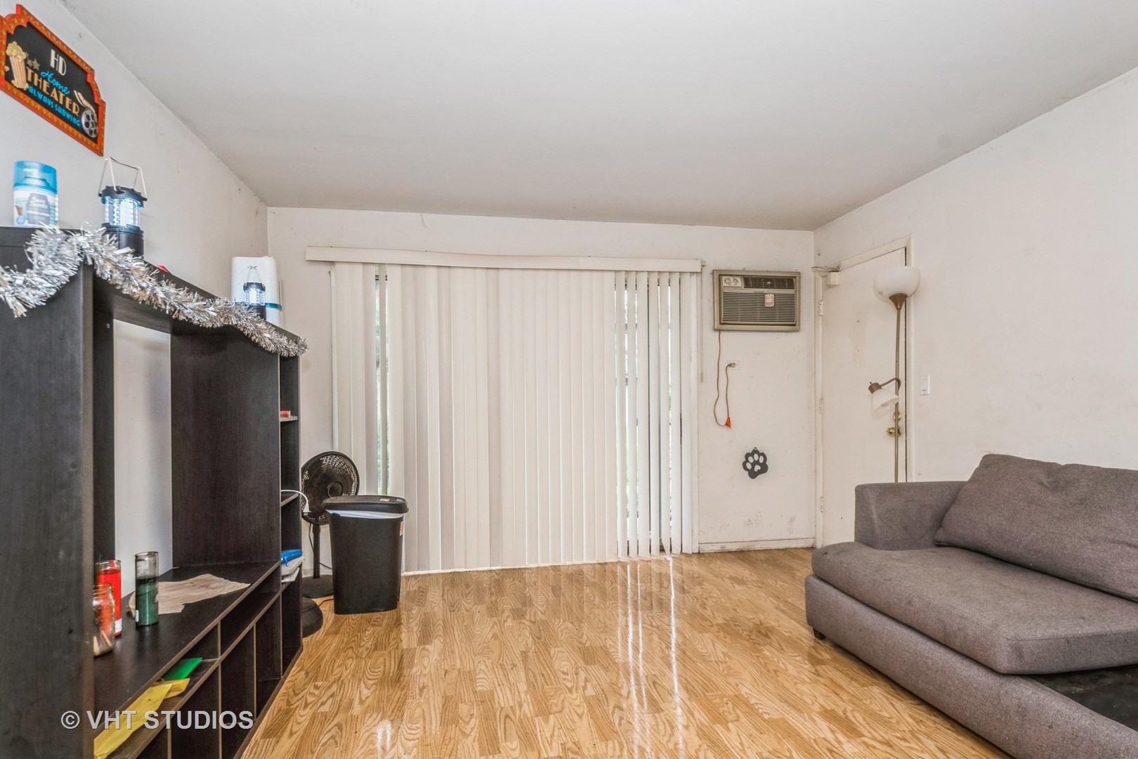 115 East Dundee Road, Unit 1S Wheeling, IL 60090 - Photo 3 of 9 a living room with furniture a refrigerator and a flat screen tv