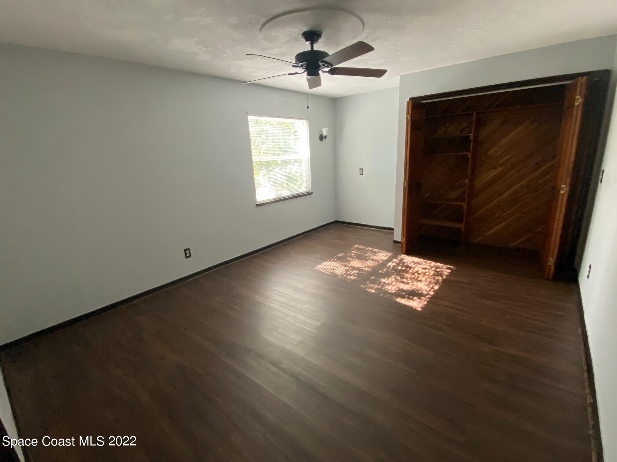 4985 Ranchland Road Melbourne, FL 32934 - Photo 7 of 13 a view of a livingroom with wooden floor and a window