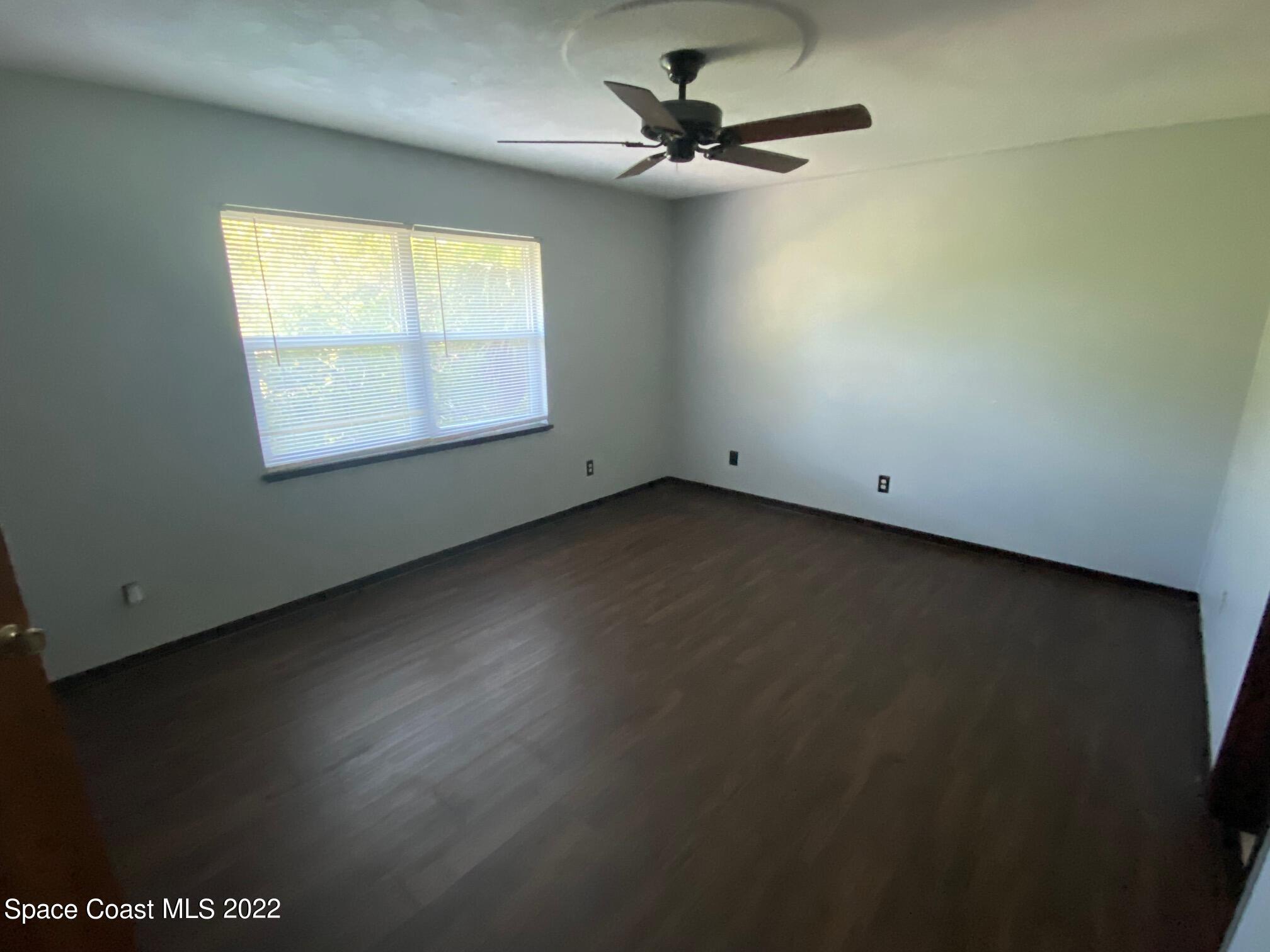 4985 Ranchland Road Melbourne, FL 32934 - Photo 9 of 13 an empty room with a window