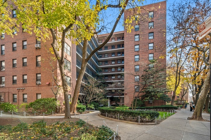 35-31 85th Street, Unit 8L Queens, NY 11372 - Photo 10 of 14 a front view of a building with garden
