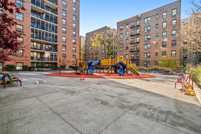 35-31 85th Street, Unit 8L Queens, NY 11372 - Photo 12 of 14 a group of cars parked in front of a building