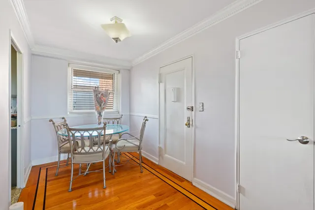 a living room with furniture a flat screen tv and kitchen view