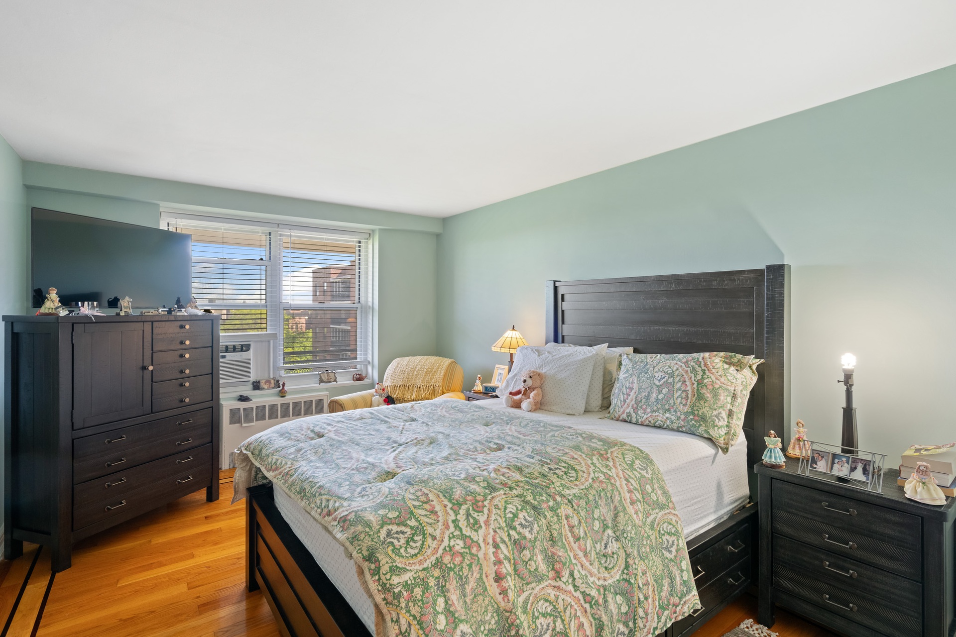 35-31 85th Street, Unit 8L Queens, NY 11372 - Photo 6 of 14 a bed room with a bed and a television