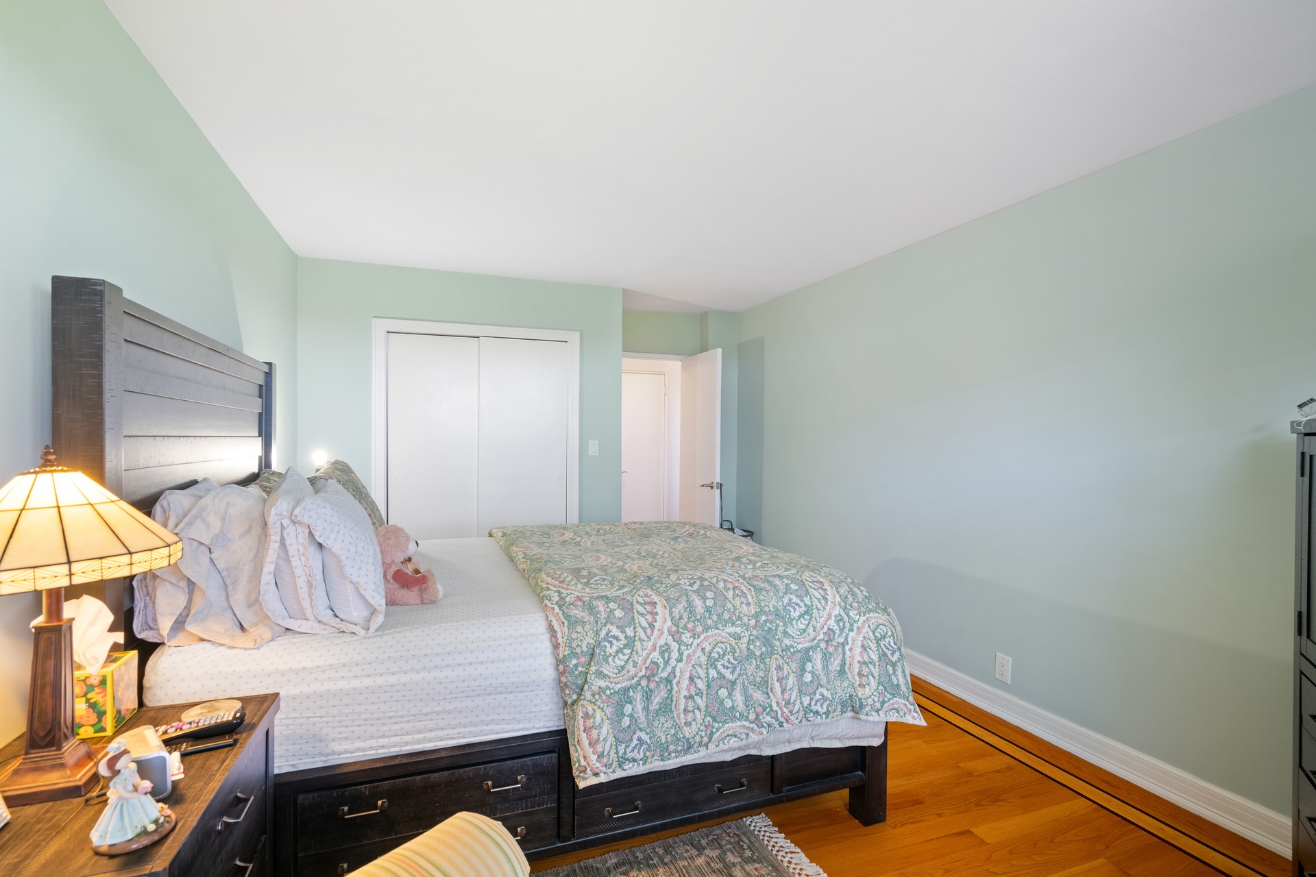 35-31 85th Street, Unit 8L Queens, NY 11372 - Photo 7 of 14 a bedroom with a bed and lamp