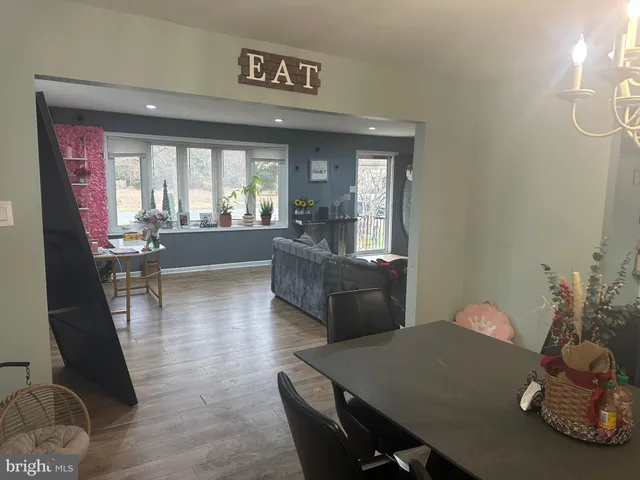 a living room with furniture window and wooden floor