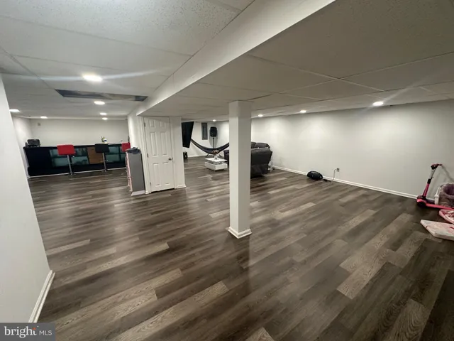 a view of a room with wooden floor