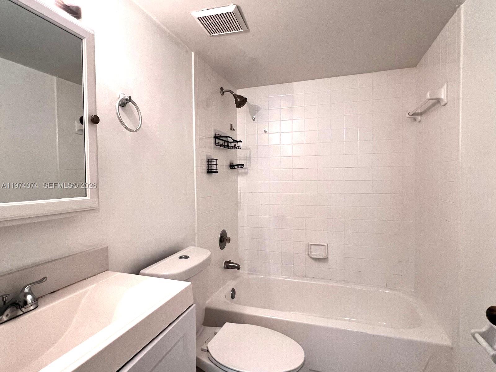 8911 Southwest 123rd Court, Unit 101 Miami, FL 33186 - Photo 12 of 15 a bathroom with a sink a toilet and a bathtub