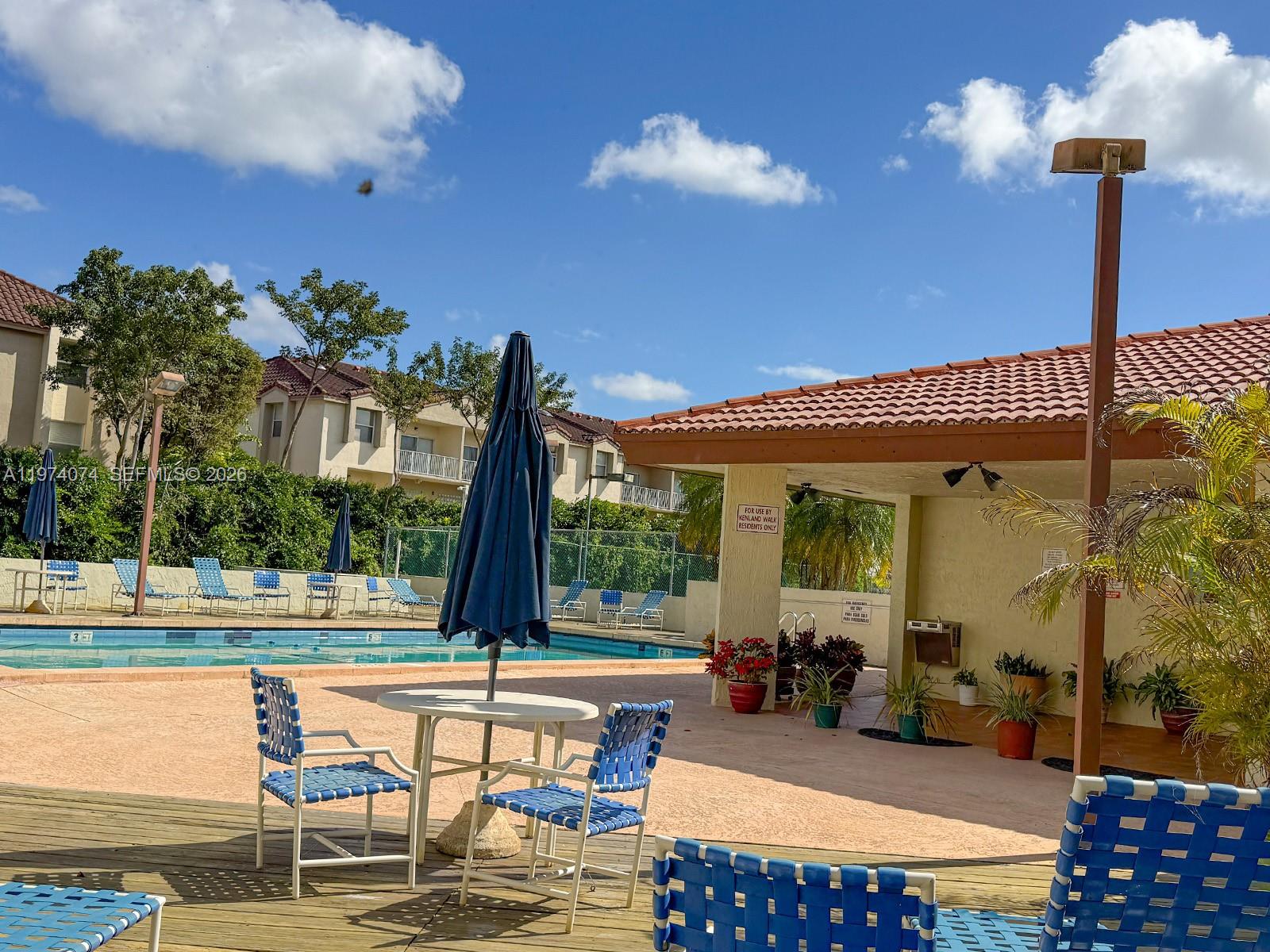 8911 Southwest 123rd Court, Unit 101 Miami, FL 33186 - Photo 14 of 15 a view of a swimming pool with a patio