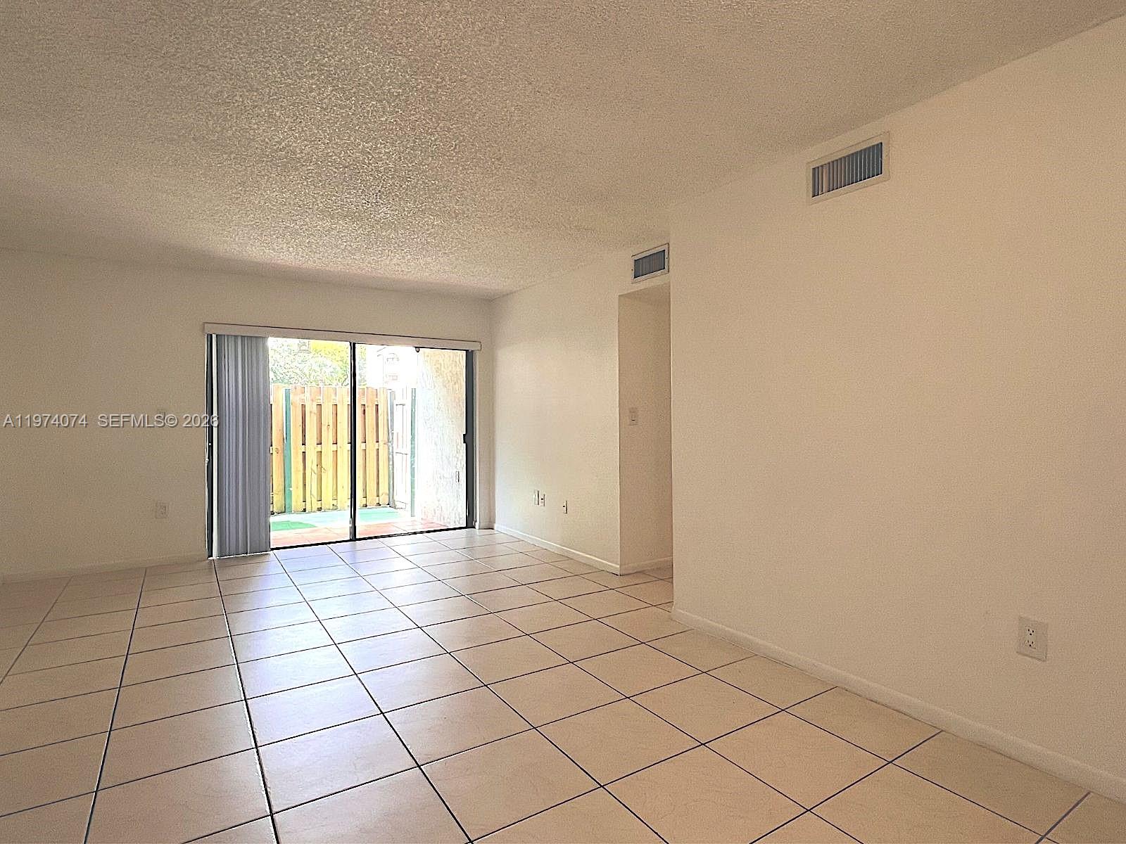 8911 Southwest 123rd Court, Unit 101 Miami, FL 33186 - Photo 7 of 15 a view of an empty room and window