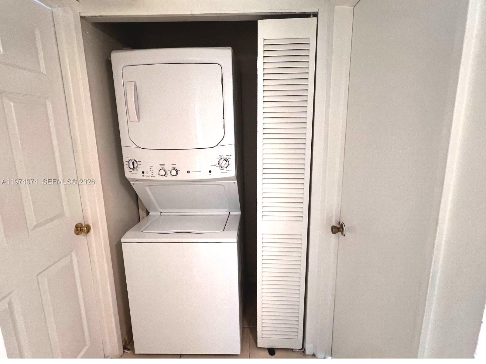 8911 Southwest 123rd Court, Unit 101 Miami, FL 33186 - Photo 9 of 15 a utility room with dryer and washer