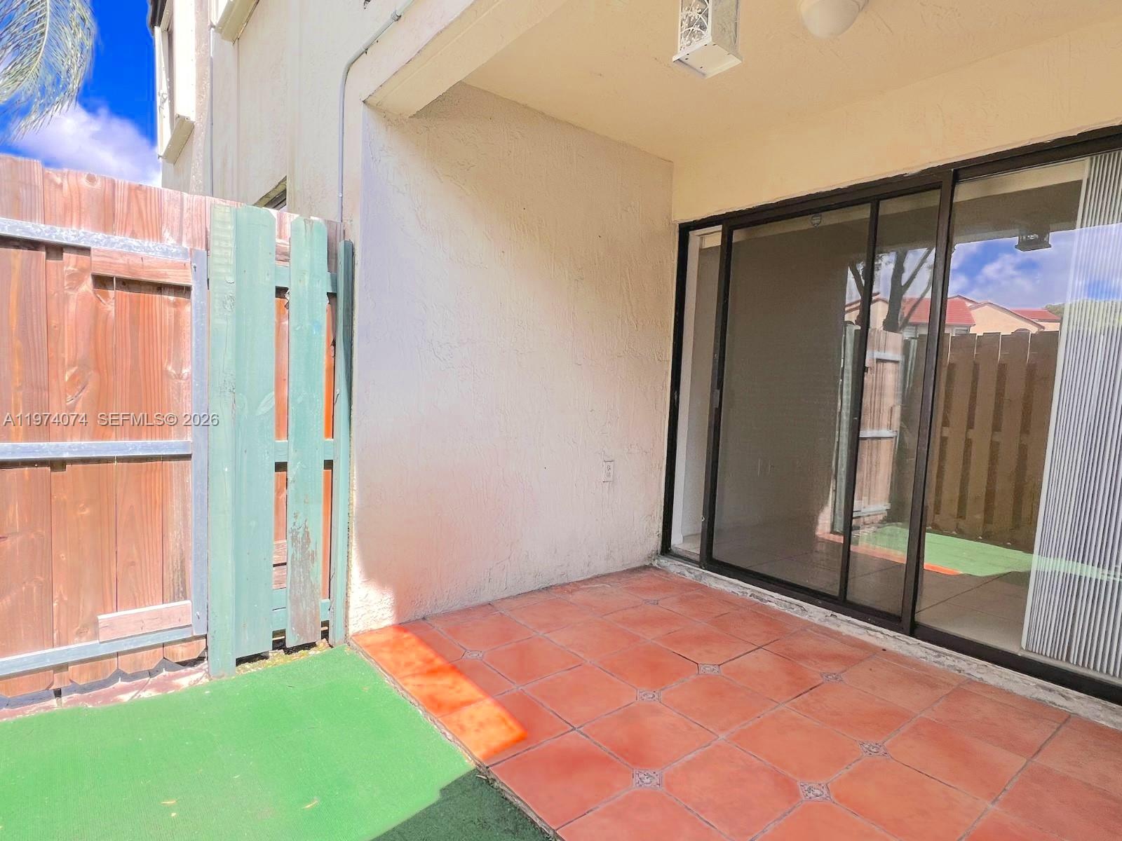 8911 Southwest 123rd Court, Unit 101 Miami, FL 33186 - Photo 10 of 15 a view of an empty room with a window