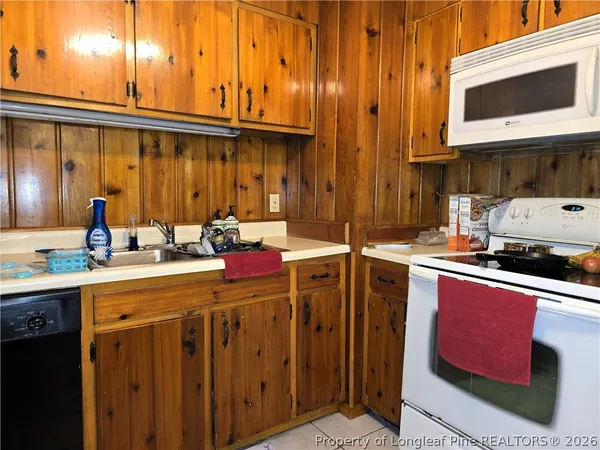a kitchen with a sink cabinets and appliances