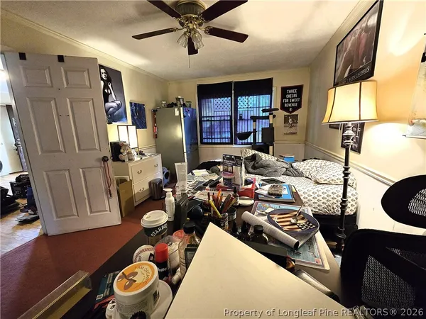 a bedroom with furniture and a window