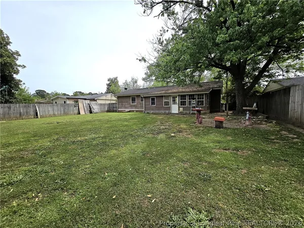 a view of a house with backyard porch and sitting area