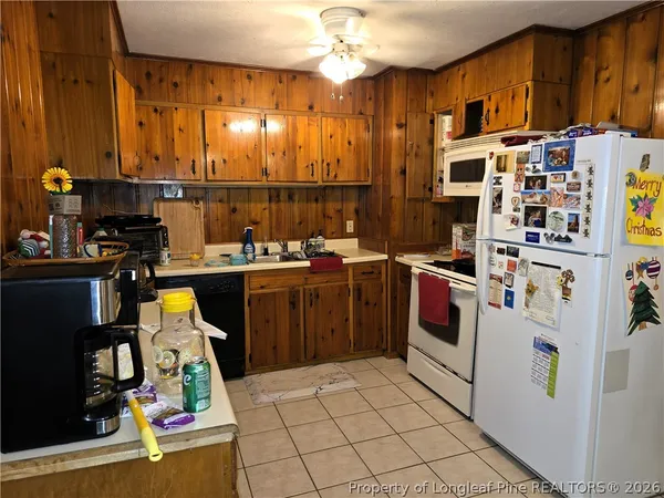 a kitchen that has a lot of cabinets and stainless steel appliances
