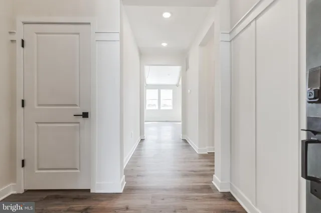 a view of a hallway with wooden floor