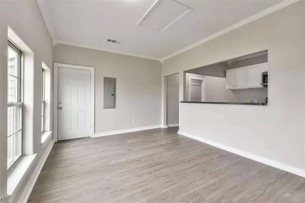 a view of a livingroom with wooden floor and cabinet