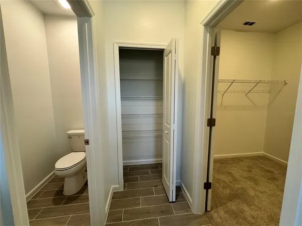 a bathroom with a granite countertop shower and a toilet