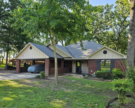 a front view of a house with a garden and yard