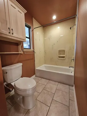 a bathroom with a toilet a sink and a shower