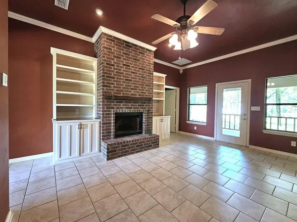 a view of livingroom with fireplace fan and window