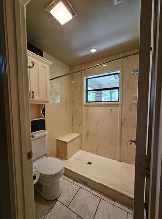 a bathroom with a toilet a sink and bathtub