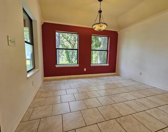 a view of an empty room with windows