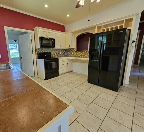 a kitchen with stainless steel appliances a refrigerator and a stove top oven