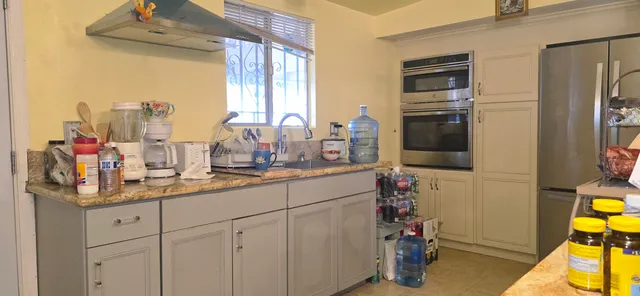 a living room with furniture and a painting on the wall