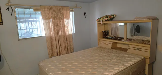 a bedroom with two beds and a lamp