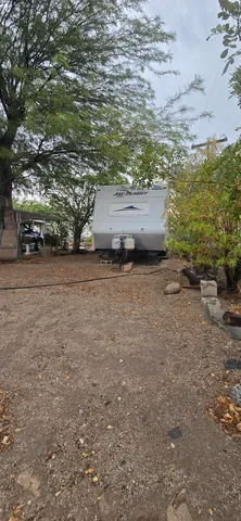 a view of a patio with table and chairs and wooden fence