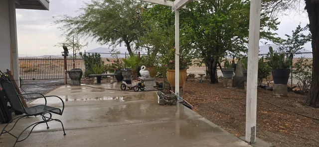 a view of a table and chairs under an umbrella