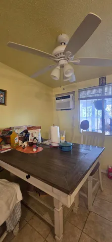 a living room with stainless steel appliances kitchen island granite countertop furniture and a kitchen view