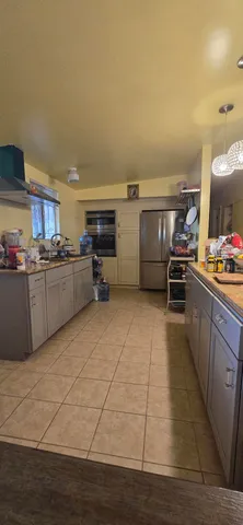 a kitchen with sink and cabinets