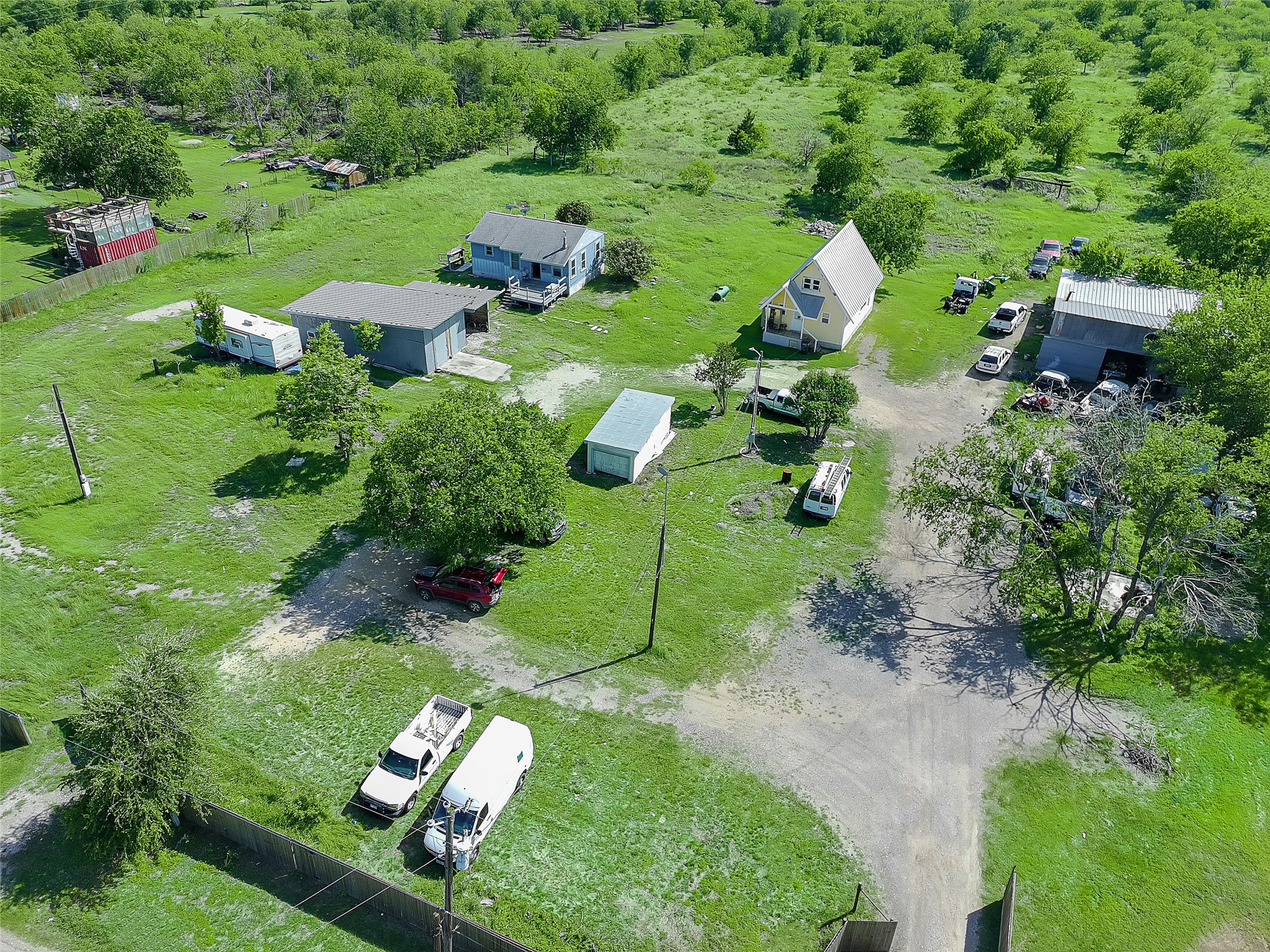 925 Long Hollow Road Dale, TX 78616 - Photo 7 of 26 Expansive property featuring multiple structures, including two residential-style buildings and a large workshop