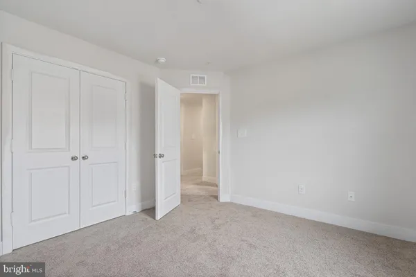 a view of an empty room and closet area