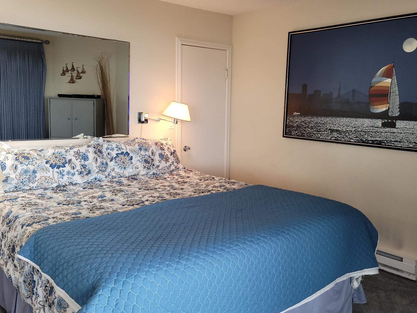 101 Shell Road, Unit 84 Watsonville, CA 95076 - Photo 35 of 40 a bedroom with a bed and painting on the wall