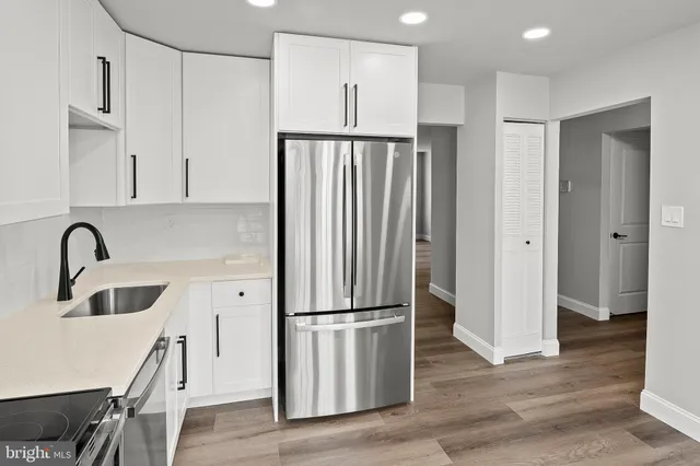a kitchen with stainless steel appliances granite countertop a refrigerator sink and cabinets