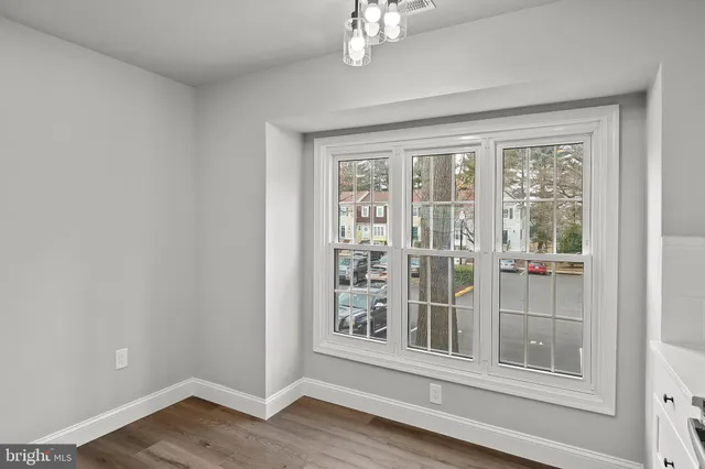 a view of a livingroom with wooden floor and windows