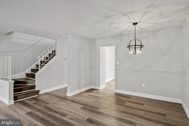a view of a room with wooden floor and stairs