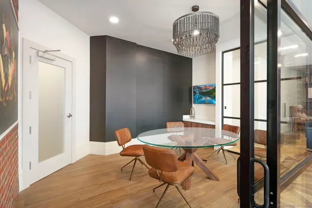 a view of a patio with dining table and chairs with wooden floor