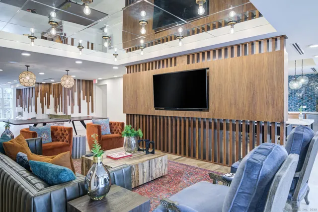 a living room with furniture fireplace and flat screen tv