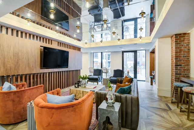 a living room with furniture and large windows
