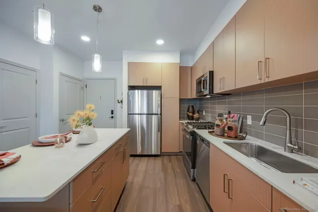 a living room with furniture and large windows