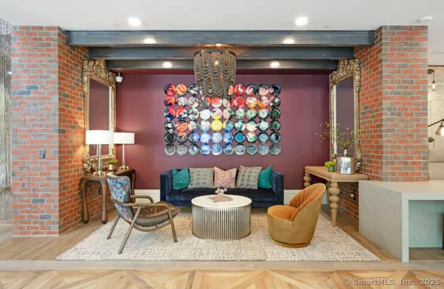 a living room with furniture and a chandelier