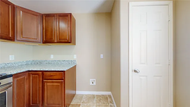 a kitchen with granite countertop a stove and a cabinets
