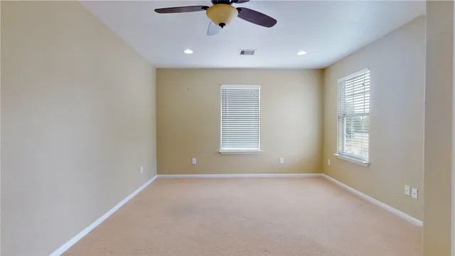 an empty room with a empty space and a ceiling fan