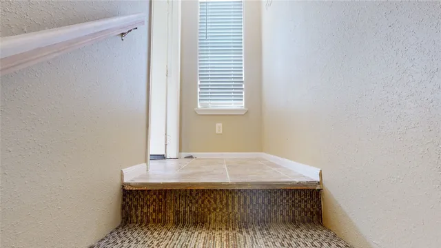 a view of an empty room with a bathroom